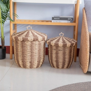 Nordic woven storage baskets with lids and star handles in a cozy home setting