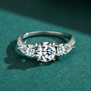 S925 sterling silver three-stone ring with a round center and pear side diamonds