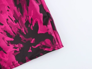 Close-up of vintage jacquard fabric with black and pink weave and refined stitching
