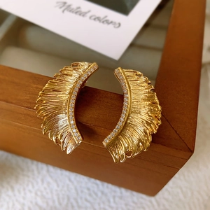 Golden leaf earrings featuring delicate brushed metal texture and sparkling crystals