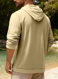 Close-up of khaki linen cotton hoodie showing breathable texture and natural drape in sunlight