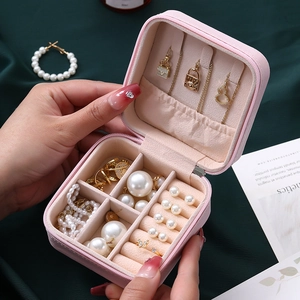 Pink portable travel jewelry organizer box with zipper and compartmentalized interior