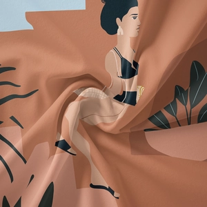 Detail of bohemian tapestry fabric showing modern female illustration and leaf patterns