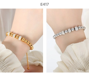 Detail of adjustable beaded bracelets in gold and silver with sparkling crystal rings