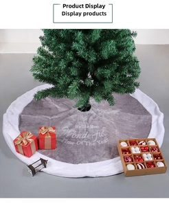 Detail of gray velvet Christmas tree skirt with white plush edge and seasonal embroidery
