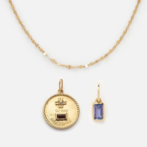 Detailed view of gold stainless steel necklace with inscribed round and zircon rectangle pendants