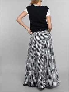 Rear view of long plaid tiered skirt featuring a high waist and black white check pattern