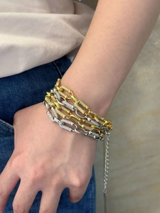 Detalle de la pulsera de cadena dorada y plateada con detalles de circonitas