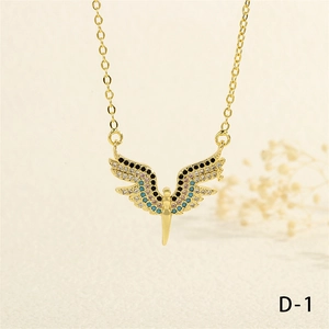 Close-up of wing pendant with colorful cubic zirconia on a gold cable chain