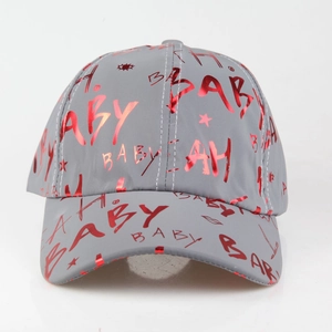 Detail of grey baseball cap featuring red metallic graffiti print and glossy fabric textures