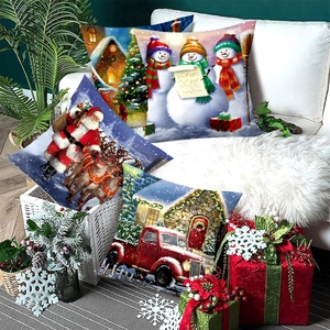 Set of four Christmas pillow covers featuring Santa Claus and snowman in festive indoor decor