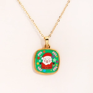 Close-up of golden necklace with Santa Claus pendant on high quality white background