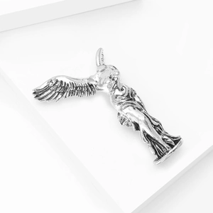 Macro shot of silver winged Nike goddess brooch with polished metallic finish
