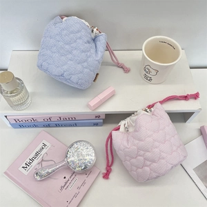 Quilted cotton drawstring organizers in blue and pink stripes with heart stitching