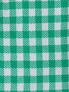 Detailed close-up of green and white houndstooth knit fabric texture and weaving