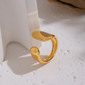 Minimalist gold geometric open ring for women on a textured white aesthetic background