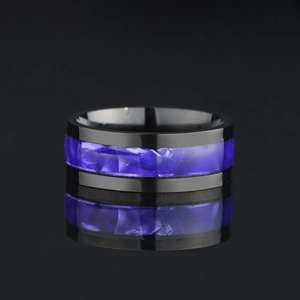 Detailed macro view of black stainless steel ring with purple shell inlay texture