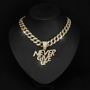 Detail of gold-plated iced out NEVER GIVE UP pendant necklace on a black bust display