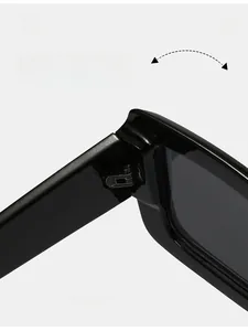 Close-up of durable metal hinge on black rectangular sunglasses with smooth finish