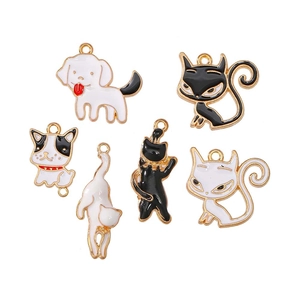 Detailed macro of six enamel metal charms featuring cat and dog designs in gold outlines