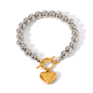 Two-tone silver and gold beaded heart bracelet with toggle clasp on white background