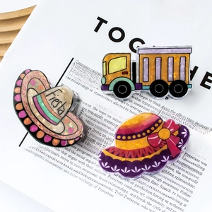 Creative acrylic hair clips featuring cartoon yellow truck and festive hat designs