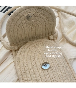 Close-up of woven bag showing the magnetic silver metal clasp and fine knit texture
