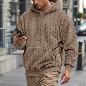 Detail view of coffee brown teddy fleece hoodie featuring textured geometric jacquard fabric
