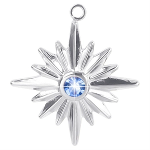 Detailed close-up of a silver starburst pendant with a sparkling blue center stone
