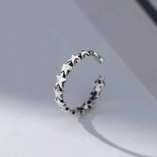 Close-up of vintage 925 silver open ring featuring a continuous five-point star pattern