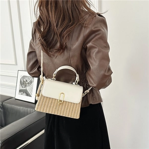 Retro straw crossbody bag with cream leather flap and gold lock shown on model