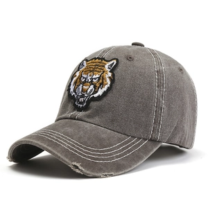 Distressed cotton baseball cap with tiger head embroidery and vintage washed finish