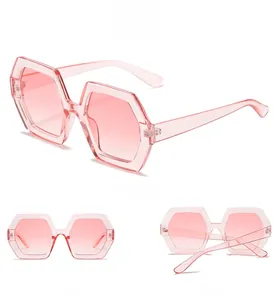 Three angles of oversized pink polygon sunglasses showing clear frames and gradient lenses