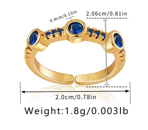 Macro detail of adjustable 18K gold ring with three blue zircons and size measurements