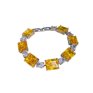 Elegant silver bracelet with rectangular yellow zircon stones and clear oval gems