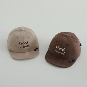 Pair of soft brim baby baseball caps in khaki and brown with Good Luck embroidery