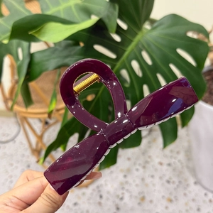 Large dark purple bow hair claw clip with elegant glossy finish and gold metal spring