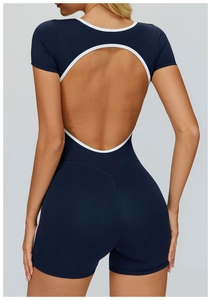 Detail of navy blue sports bodysuit with circular back cutout and white contrast trim
