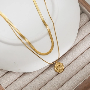 Double-layered gold necklace with flat snake chain and rose embossed coin pendant