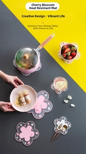 Macro detail of cherry blossom shaped heat resistant PVC coasters on modern table
