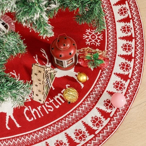 Knitted Christmas tree skirt with reindeer and snowflake patterns in red and white colors
