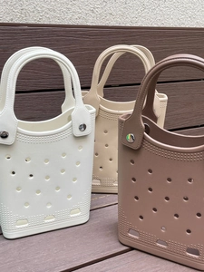 Close-up of waterproof EVA beach tote bags showing round vents and rivet handle details