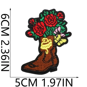 Close-up of embroidered brown cowboy boot patch with floral rose detail and size markings