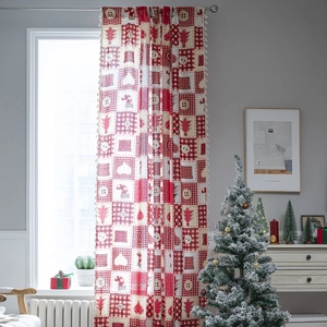 Christmas red plaid curtains with buttons and tassels hanging on a silver rod