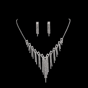 Detailed close-up of sparkling bridal necklace and earring set with silver fringe tassels