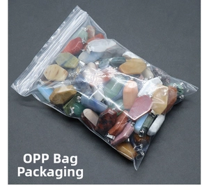 Detailed view of assorted natural stone coffin pendants in clear OPP bag packaging