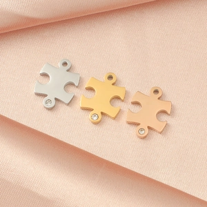 Three-piece puzzle pendant set in silver, gold and rose gold with small diamond accents