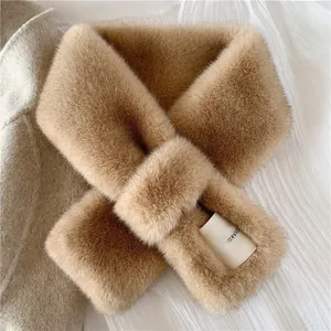Detail view of camel faux fur scarf with a woven label on soft textured fabric