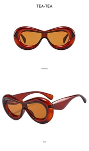 Detailed views of chunky Y2K style sunglasses with amber frames and orange tinted lenses