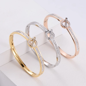 Three-color diamond-set bangle display in gold, silver, and rose gold finishes